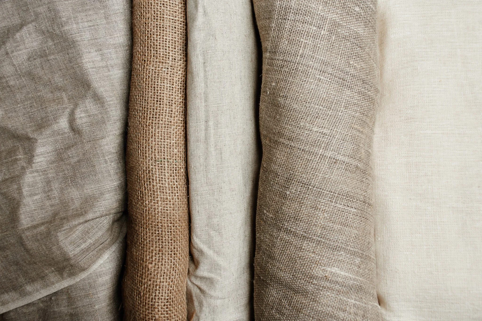 Natural fabrics from organic colors of flax and cotton in rolls AdobeStock 258460212 scaled